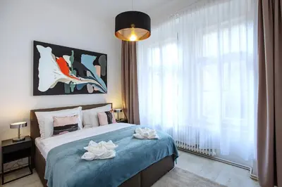 a bedroom with a bed and a large window at 5BR 2BATH family APT 5mins to Wenceslas square in Prague