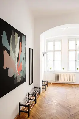 a room with two benches and a large painting on the wall at 5BR 2BATH family APT 5mins to Wenceslas square in Prague