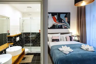 a bedroom with a bed and a bathroom with a sink at 5BR 2BATH family APT 5mins to Wenceslas square in Prague