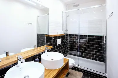 a bathroom with two sinks and a glass shower at 5BR 2BATH family APT 5mins to Wenceslas square in Prague
