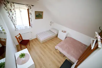 a small living room with a table and a chair at Restaurace a pension Chalupa in Vorder Třebau