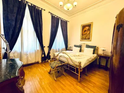 a bedroom with a bed and two large windows at Platnéřská ,7 in Prague