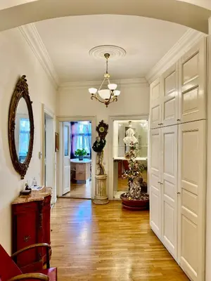 a living room with a large white door and a mirror at Platnéřská ,7 in Prague
