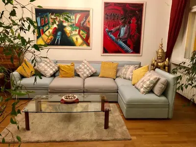 a living room with a couch and paintings on the wall at Platnéřská ,7 in Prague