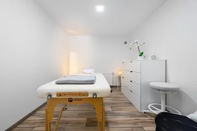 a room with a bed and a stool in it at Wellness Rooms Central in Prague
