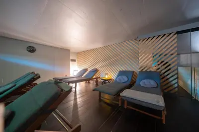 a waiting room with blue chairs and a table at Wellness Rooms Central in Prague