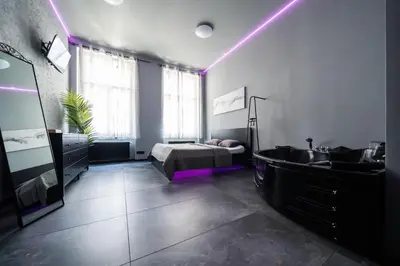 a bedroom with a bed and a tub and a sink at Wellness Rooms Central in Prague