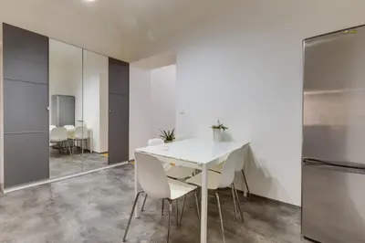 a dining room with a white table and chairs at Lovely Apartments Heart of Prague in Prague