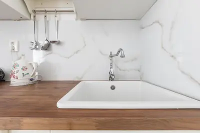 a kitchen with a white sink on a counter at Lovely Apartments Heart of Prague in Prague