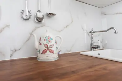 a tea kettle sitting on a counter in a bathroom at Lovely Apartments Heart of Prague in Prague