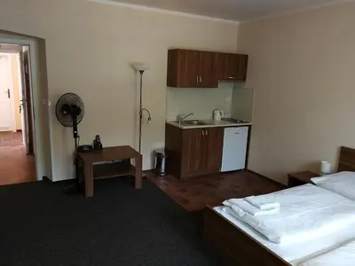 a hotel room with two beds and a kitchen at Apartments U Švejků in Prague