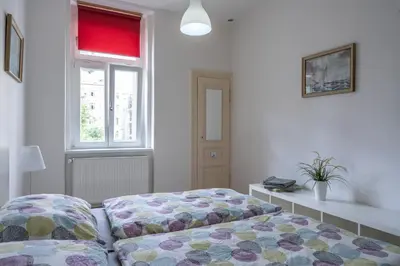 a bedroom with a bed and a window at TopApartmany in Prague