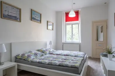 a bedroom with a bed and a window at TopApartmany in Prague