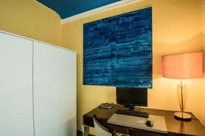 a desk with a computer and a lamp on it at Charles Bridge Hostel & Apartments in Prague
