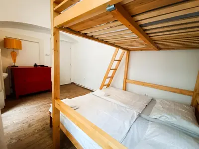 a bedroom with a bunk bed with a ladder at Charles Bridge Hostel & Apartments in Prague