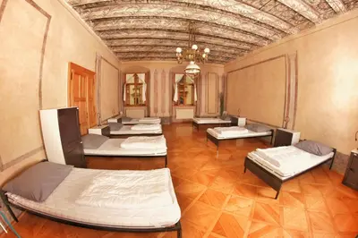 a room with several mattresses in it with a ceiling at Hostel HOMEr - Old Town Square in Prague