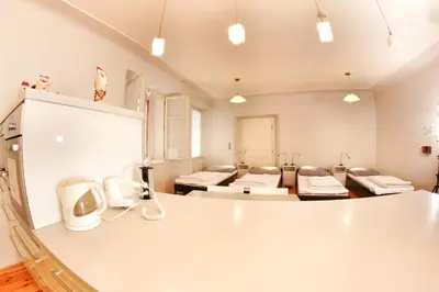 a large room with four beds in it at Hostel HOMEr - Old Town Square in Prague