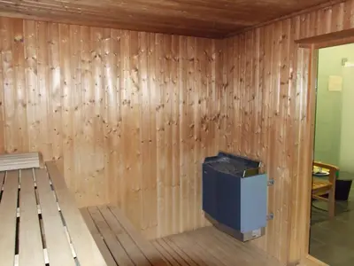 a room with a wooden wall with a tv in it at Hotel Beroun Golf Club in Beroun