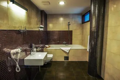 a bathroom with a sink and a bath tub at Hotel Beroun Golf Club in Beroun