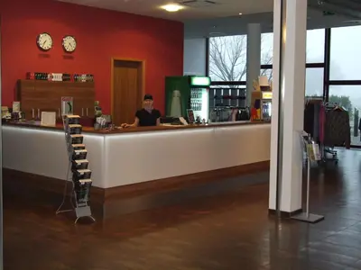 a man sitting at a counter in a restaurant at Hotel Beroun Golf Club in Beroun