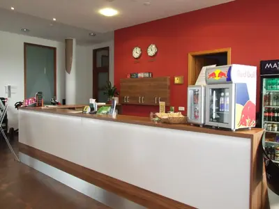 a counter in a fast food restaurant with a microwave at Hotel Beroun Golf Club in Beroun