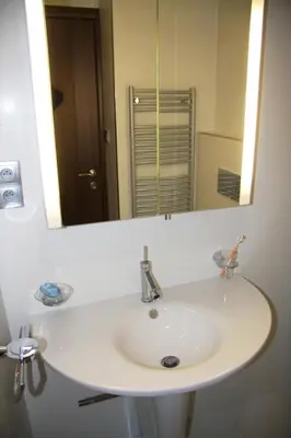 a white sink in a bathroom with a mirror at Art Hotel Podebrady in Poděbrady