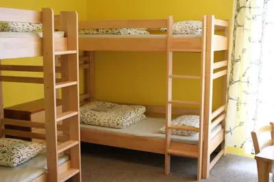 a bunk bed room with three bunk beds in it at Hostel Příběh in Týnec nad Sázavou