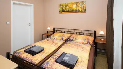 a bedroom with a bed with two bags on it at Apartment Four Year Seasons - WALKABLE TO CENTRE, METRO AND RIVERSIDE in Prague