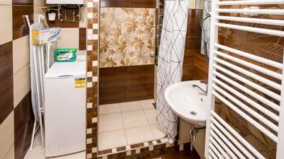 a small bathroom with a sink and a refrigerator at Apartment Four Year Seasons - WALKABLE TO CENTRE, METRO AND RIVERSIDE in Prague