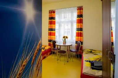 a room with a table and chairs and a window at Apartment Four Year Seasons - WALKABLE TO CENTRE, METRO AND RIVERSIDE in Prague