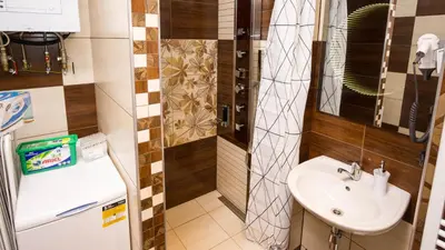 a small bathroom with a sink and a mirror at Apartment Four Year Seasons - WALKABLE TO CENTRE, METRO AND RIVERSIDE in Prague