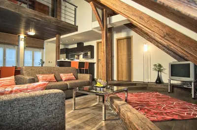 a living room with a couch and a tv at Residence Rybna in Prague