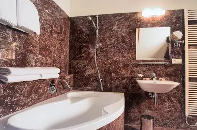 a bathroom with a tub and a sink at Residence Rybna in Prague
