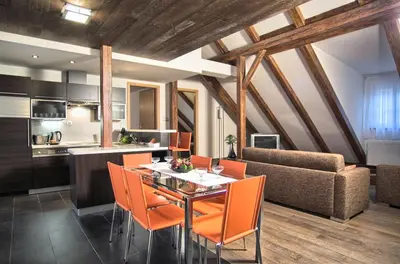 a kitchen and dining room with a table and chairs at Residence Rybna in Prague