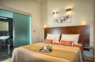 a hotel room with a bed with a tray on it at Residence Rybna in Prague