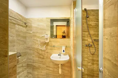a bathroom with a sink and a shower at Basement Room Old Town in Prague