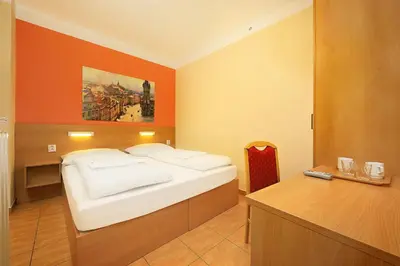 a bedroom with a bed and a desk in it at Basement Room Old Town in Prague
