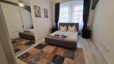 a bedroom with a bed and a large window at Apartment near Congress Centre I. in Prague