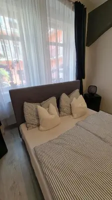a bedroom with a bed with pillows and a window at Apartment near Congress Centre I. in Prague