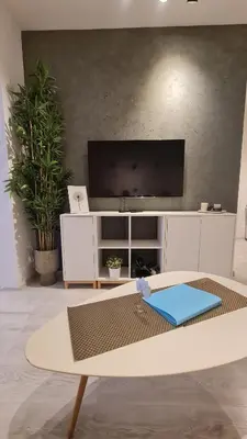 a living room with a tv and a table at Apartment near Congress Centre I. in Prague