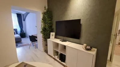 a living room with a television on a white cabinet at Apartment near Congress Centre I. in Prague