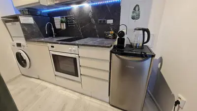 a small kitchen with a stove and a refrigerator at Apartment near Congress Centre I. in Prague