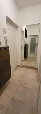 an empty room with a kitchen and a hallway at Apartment near Congress Centre I. in Prague