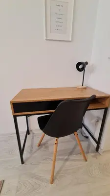 a desk with a chair sitting in front of it at Apartment near Congress Centre I. in Prague