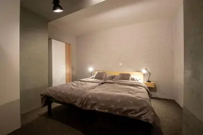 a bedroom with a large bed with two pillows at Apartmány Caffe & Grill in Roudnice nad Labem