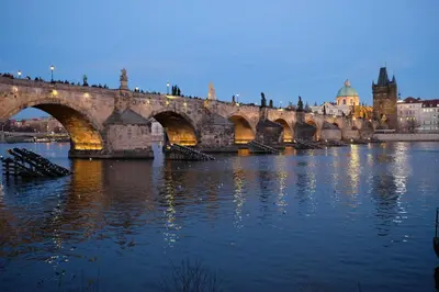 a bridge over the water in front of a city at Pawlansky Residence in Prague