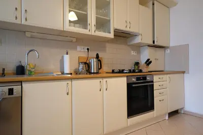 a kitchen with white cabinets and a stove top oven at Pawlansky Residence in Prague