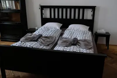 two beds with towels and a bow tie on them at Pawlansky Residence in Prague