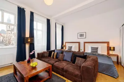 a living room with a couch and a bed at Old Town Square Premium Residence in Prague