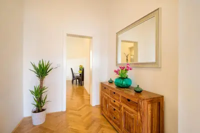 a room with a dresser with a mirror and plants at Old Town Square Premium Residence in Prague